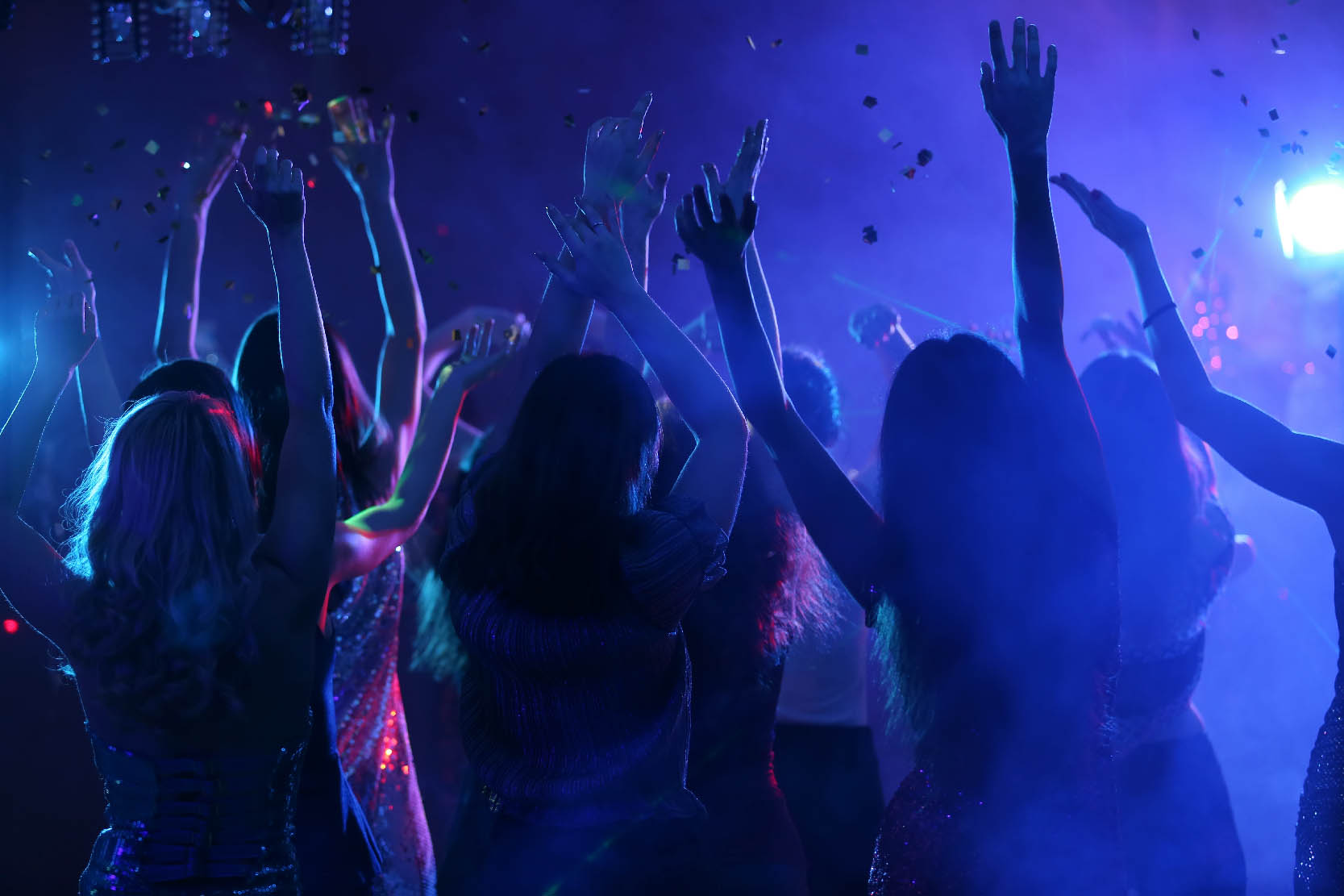 A group of young people clubbing at happy hour.